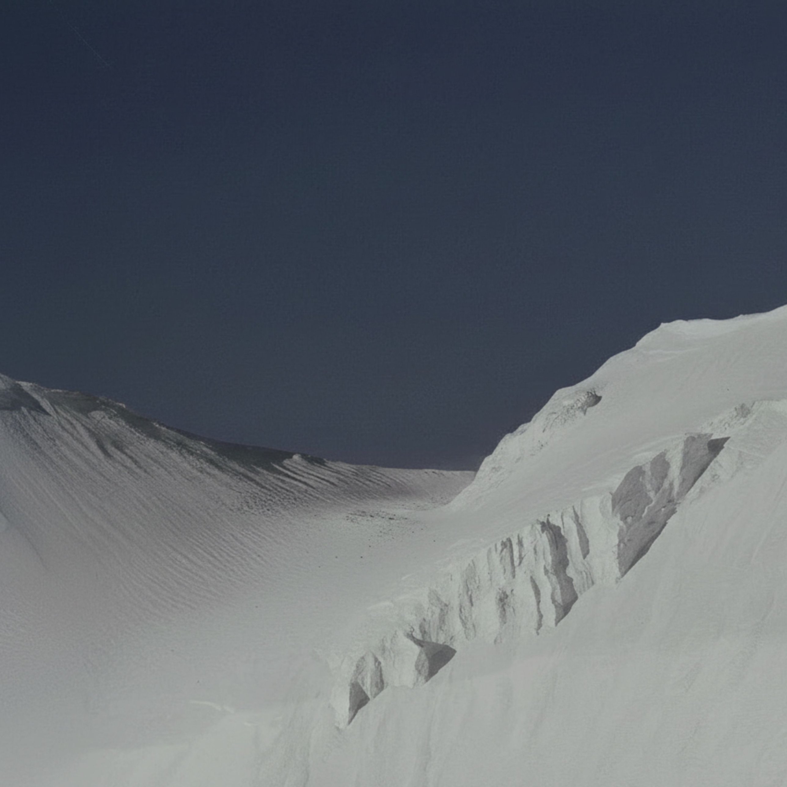 Snow cornice against a deep blue sky